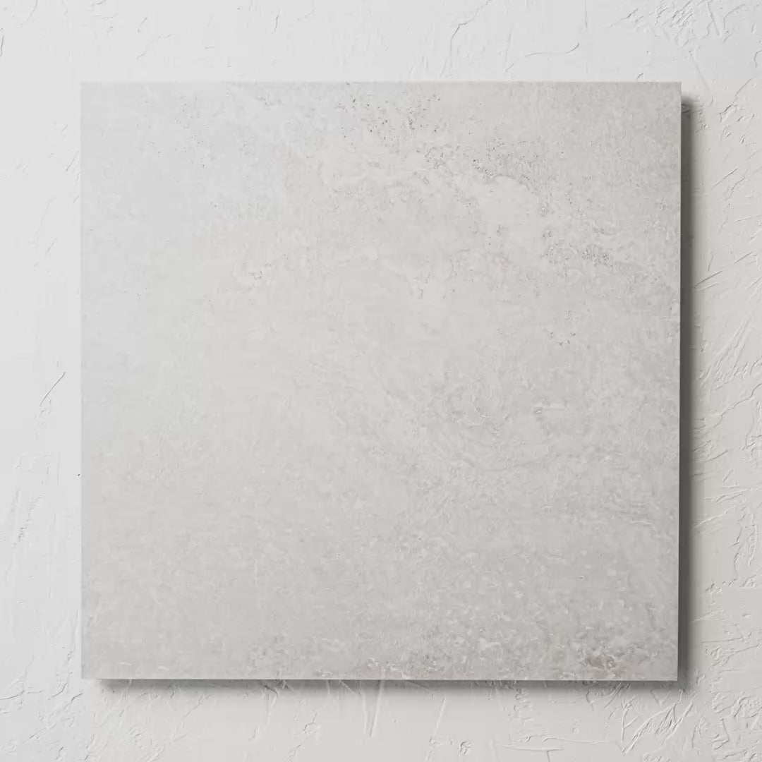 Norcia Travertine Light External Rectified Paver 600X600X20Mm tile shown in hand