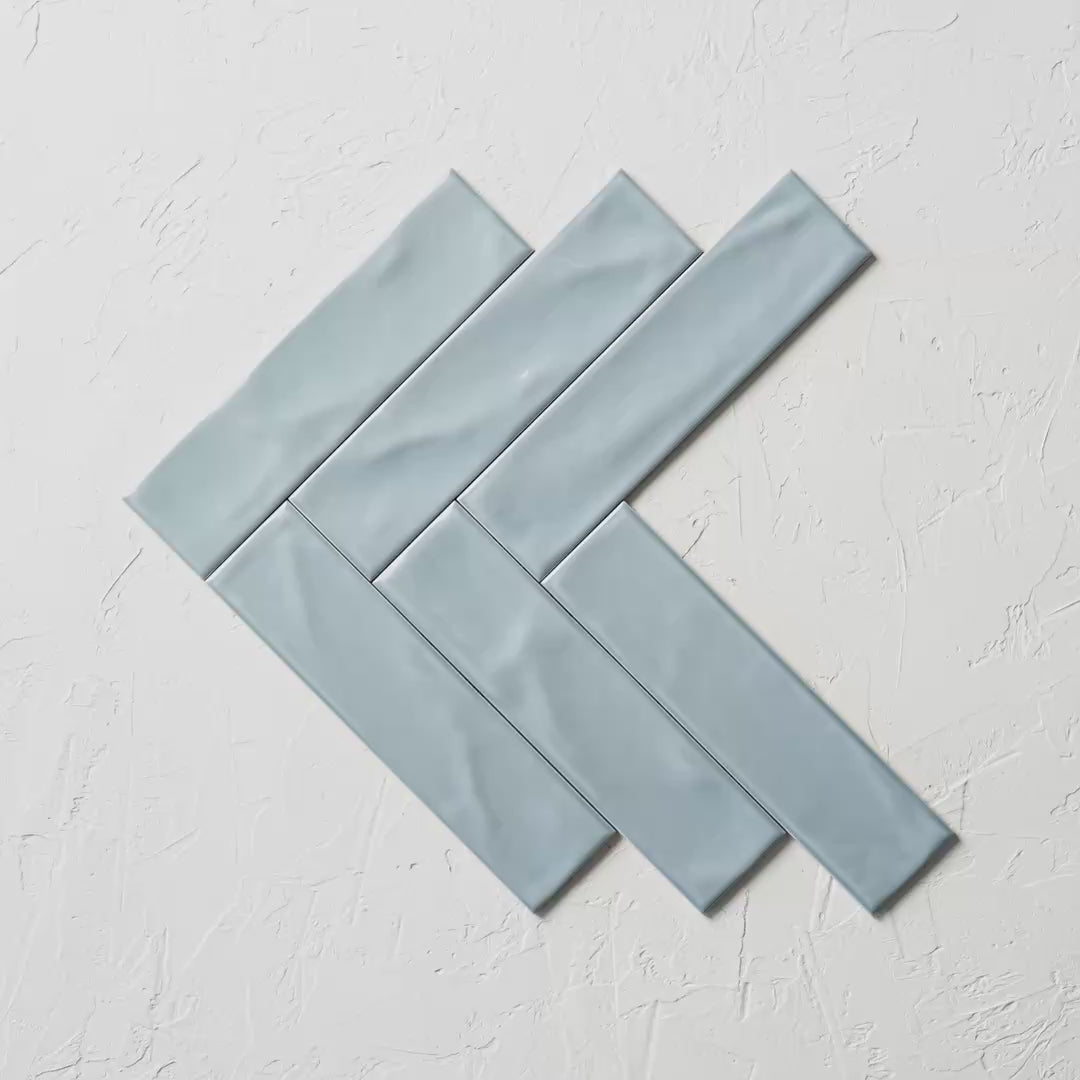 Pasha Turquoise Gloss 75X300Mm tile shown in hand