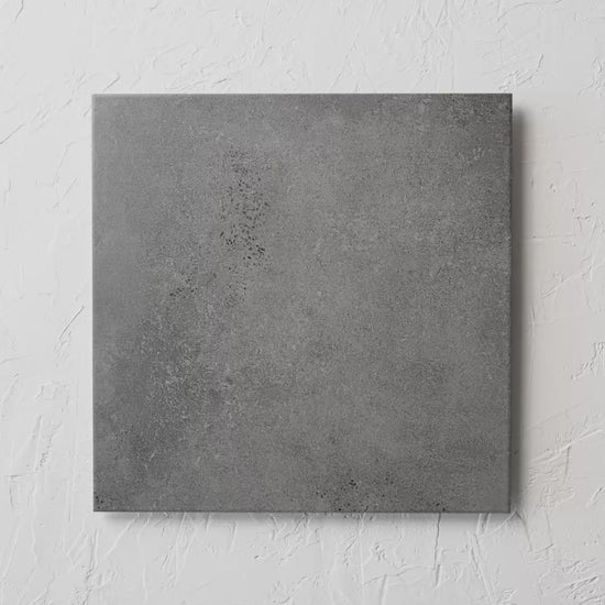 Kiewarra Charcoal 450X450Mm tile shown in hand
