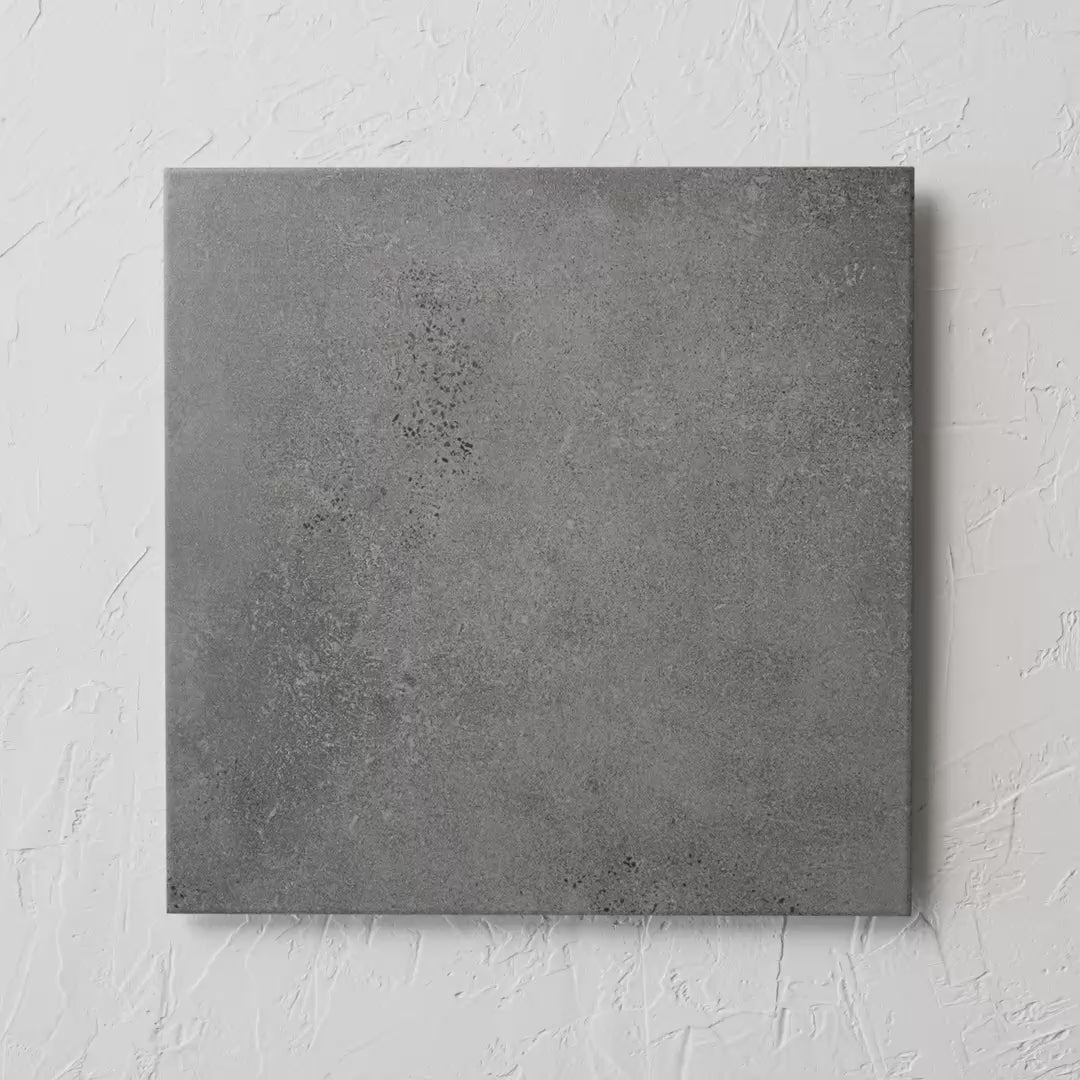 Kiewarra Charcoal 450X450Mm tile shown in hand