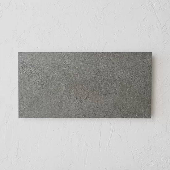 Oslo Charcoal Rectified 300X600Mm tile shown in hand