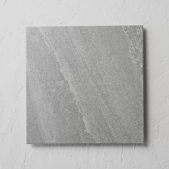 Florence Cloudy Grey 450X450Mm tile shown in hand