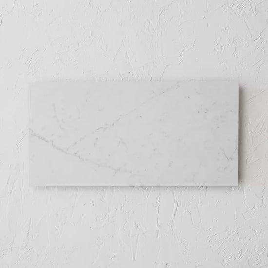 Carrara Luce Matt Rectified 300X600Mm tile shown in hand