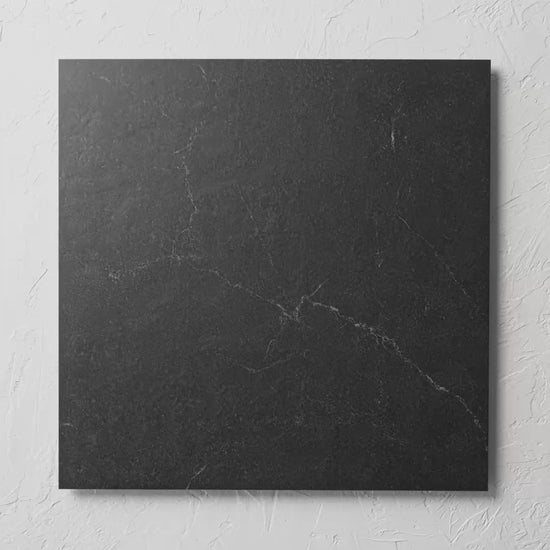 Lava Black 600X600Mm tile shown in hand