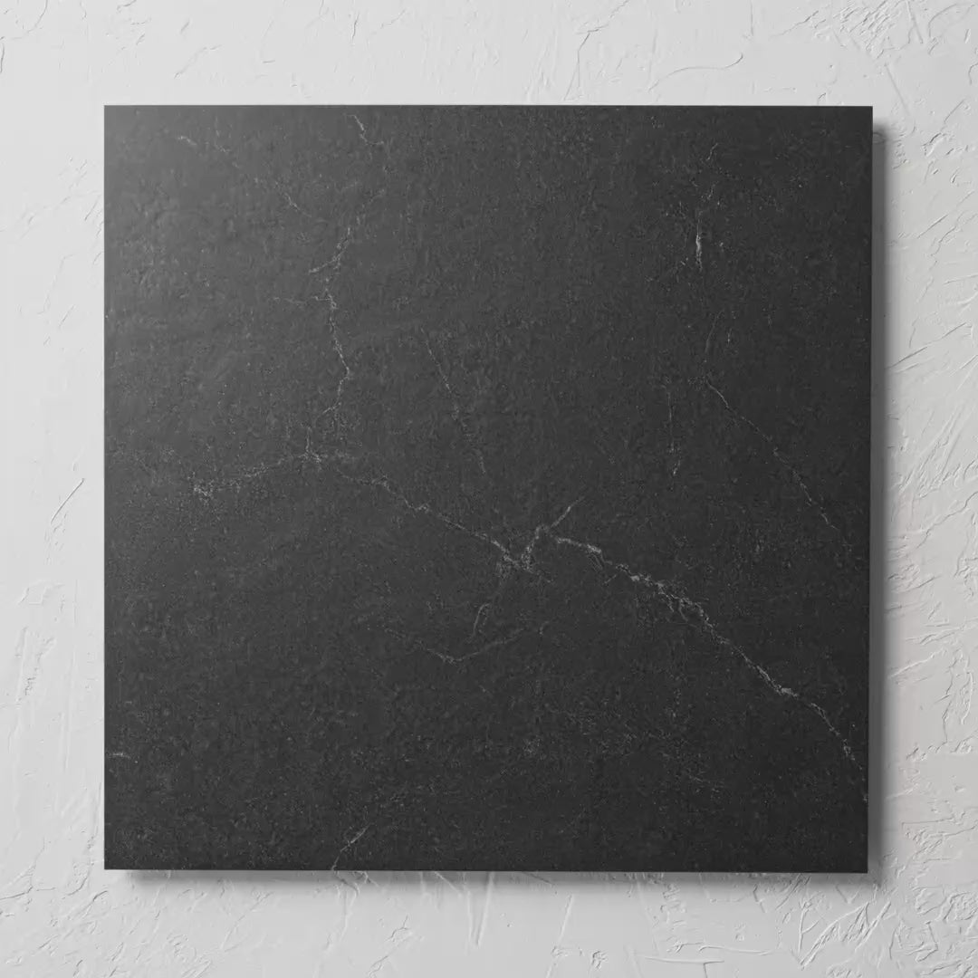 Lava Black 600X600Mm tile shown in hand