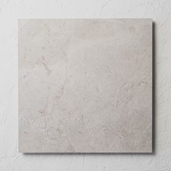 Riviera Ivory 600X600Mm tile shown in hand