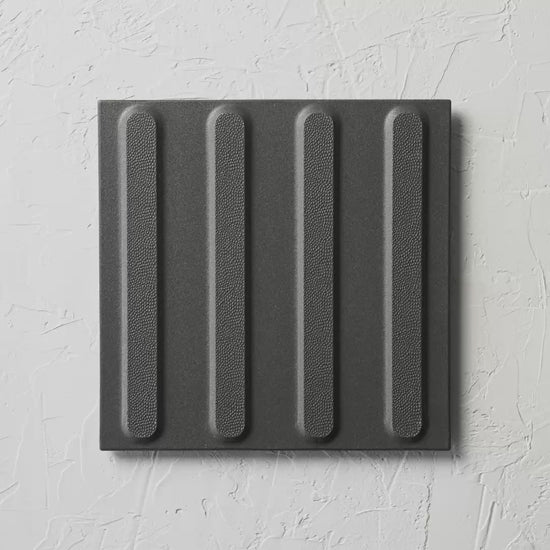 Directional Black Non Slip Tactile 300X300Mm tile shown in hand