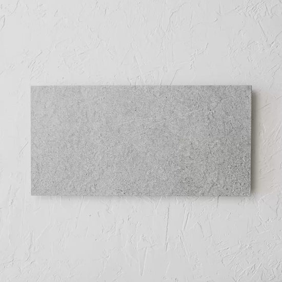 Dginostra Perla Rectified 300X600Mm tile shown in hand