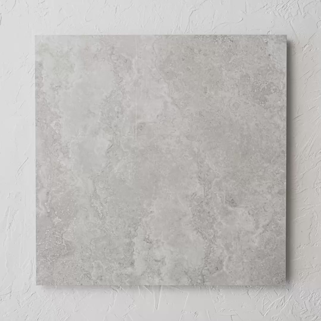 New Travertino Ivory Polished Rectified 600X600Mm tile shown in hand