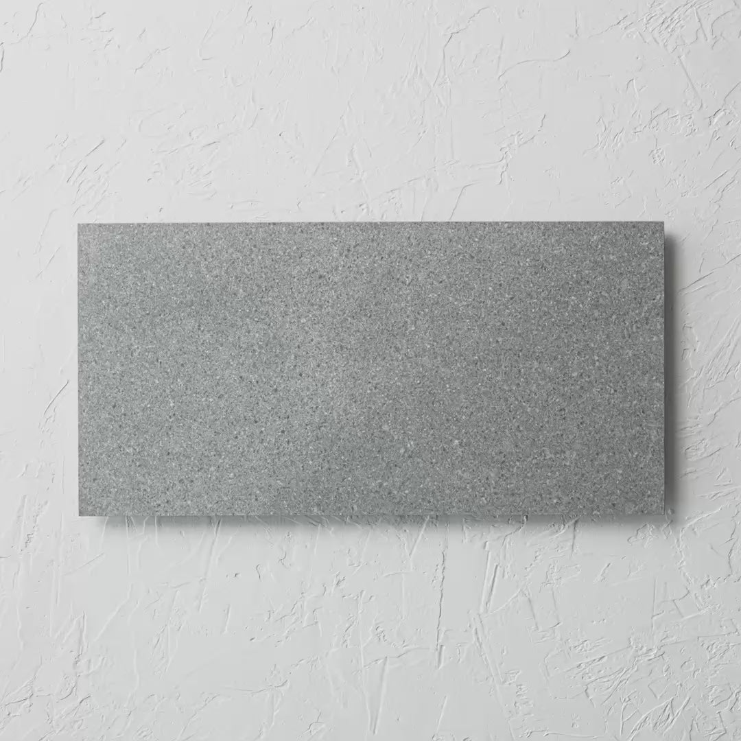 Djeju Grey Rectified 300X600Mm tile shown in hand
