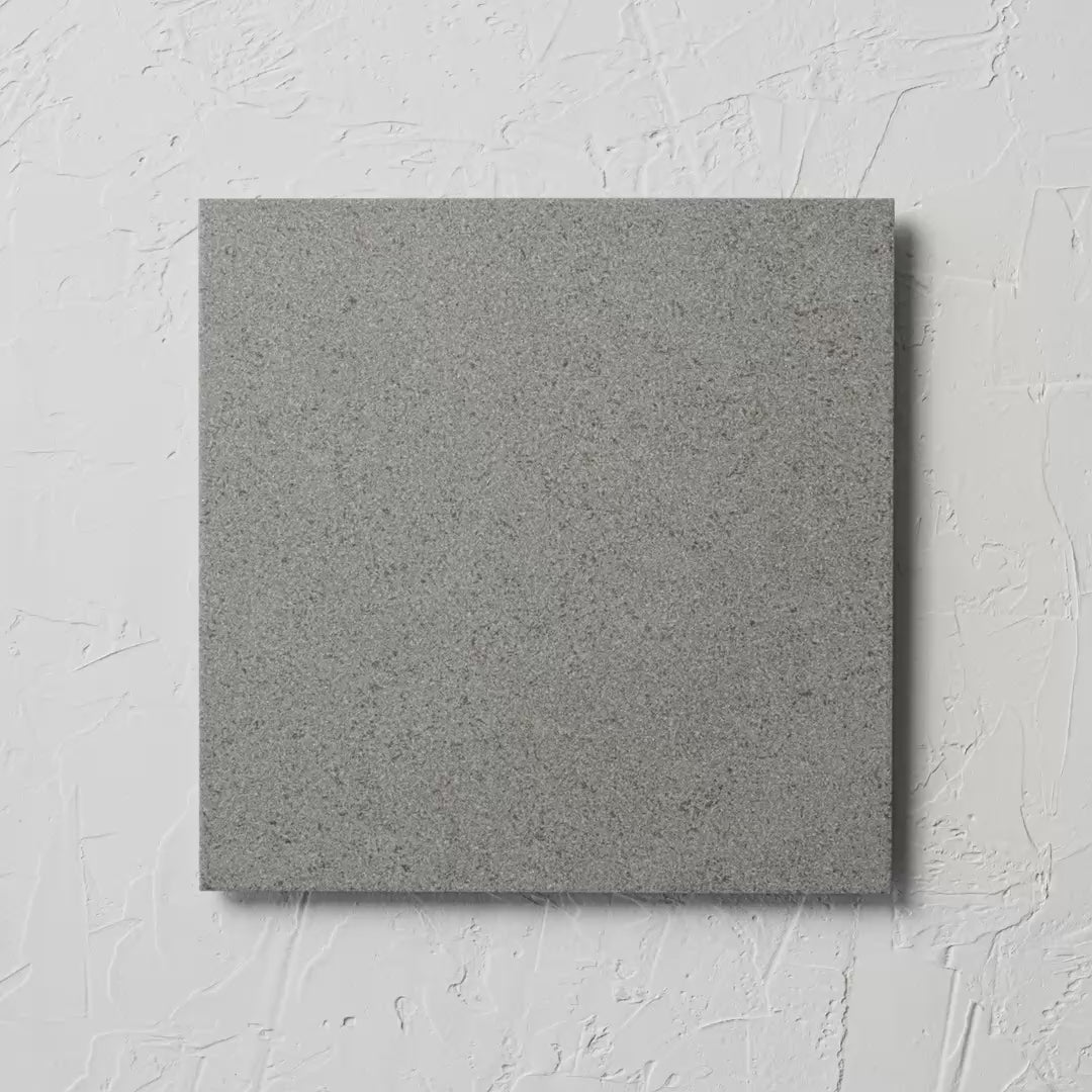 Artech Grey 300X300Mm tile shown in hand