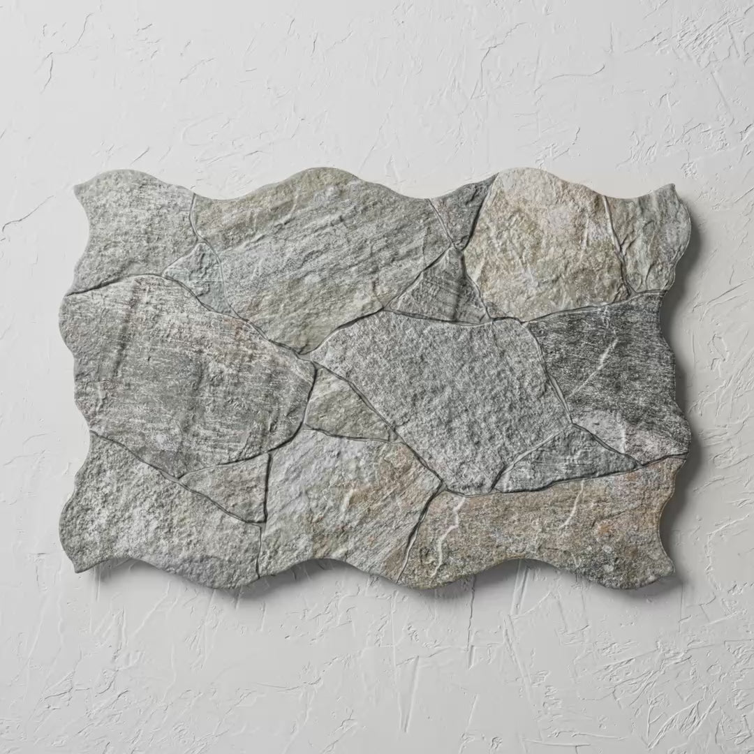 Deva Gris 440X660Mm tile shown in hand