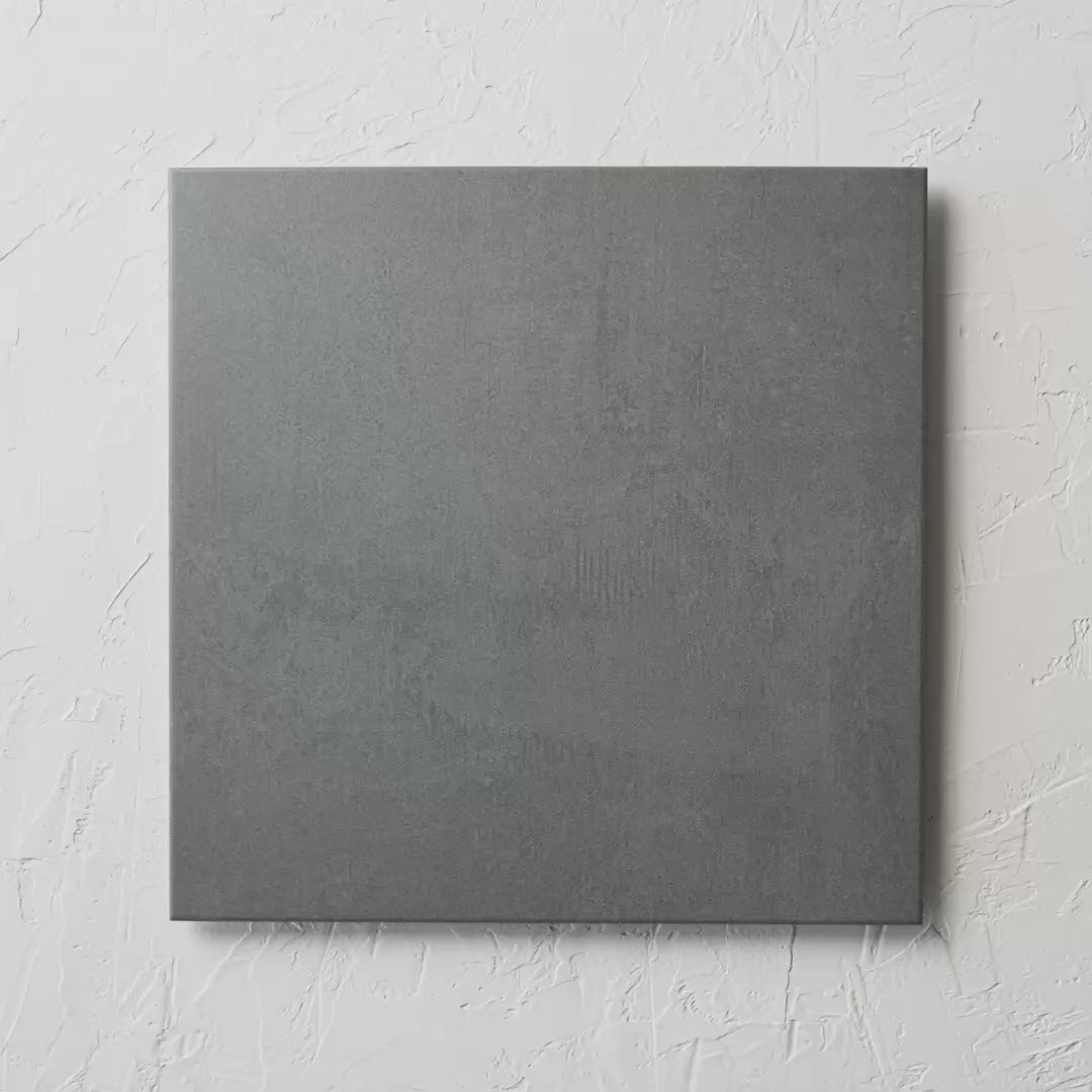 Castle Dark Grey Matte 450X450Mm tile shown in hand