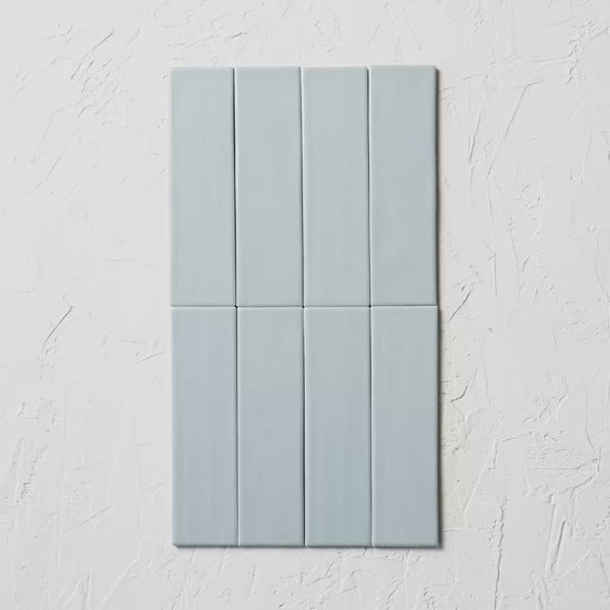 Brava Rustic Blue Satin 60X217Mm tile shown in hand