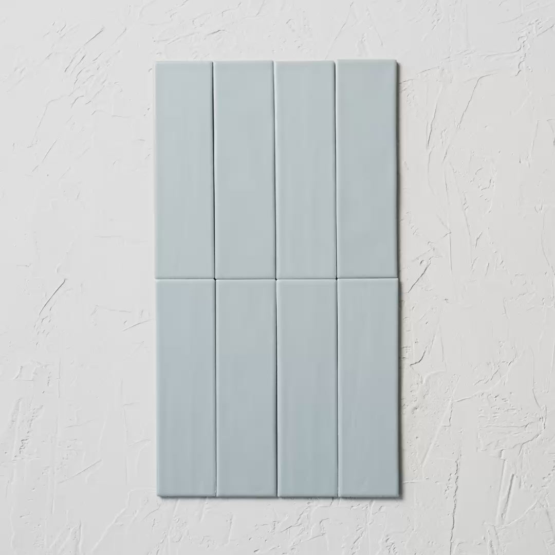 Brava Rustic Blue Satin 60X217Mm tile shown in hand