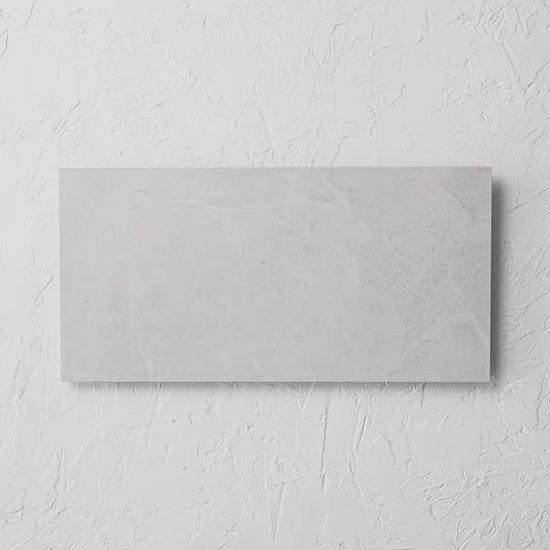 Bora White Matt Rectified 300X600Mm tile shown in hand