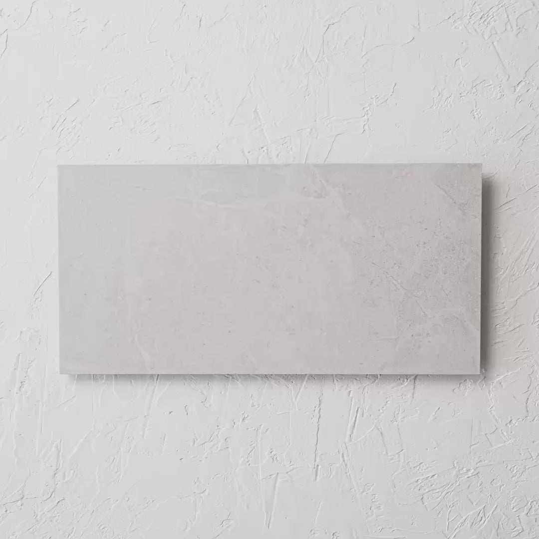 Bora White Matt Rectified 300X600Mm tile shown in hand