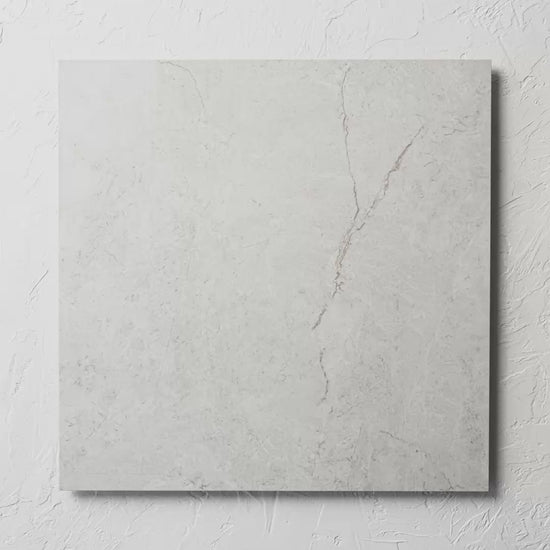 Riviera Light 600X600Mm tile shown in hand