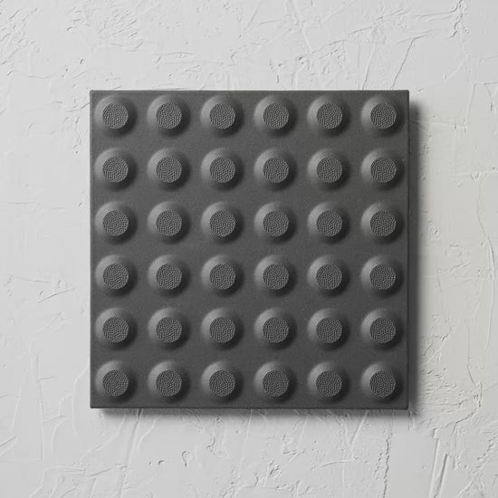 Hazard Black Non Slip Tactile 300X300Mm tile shown in hand