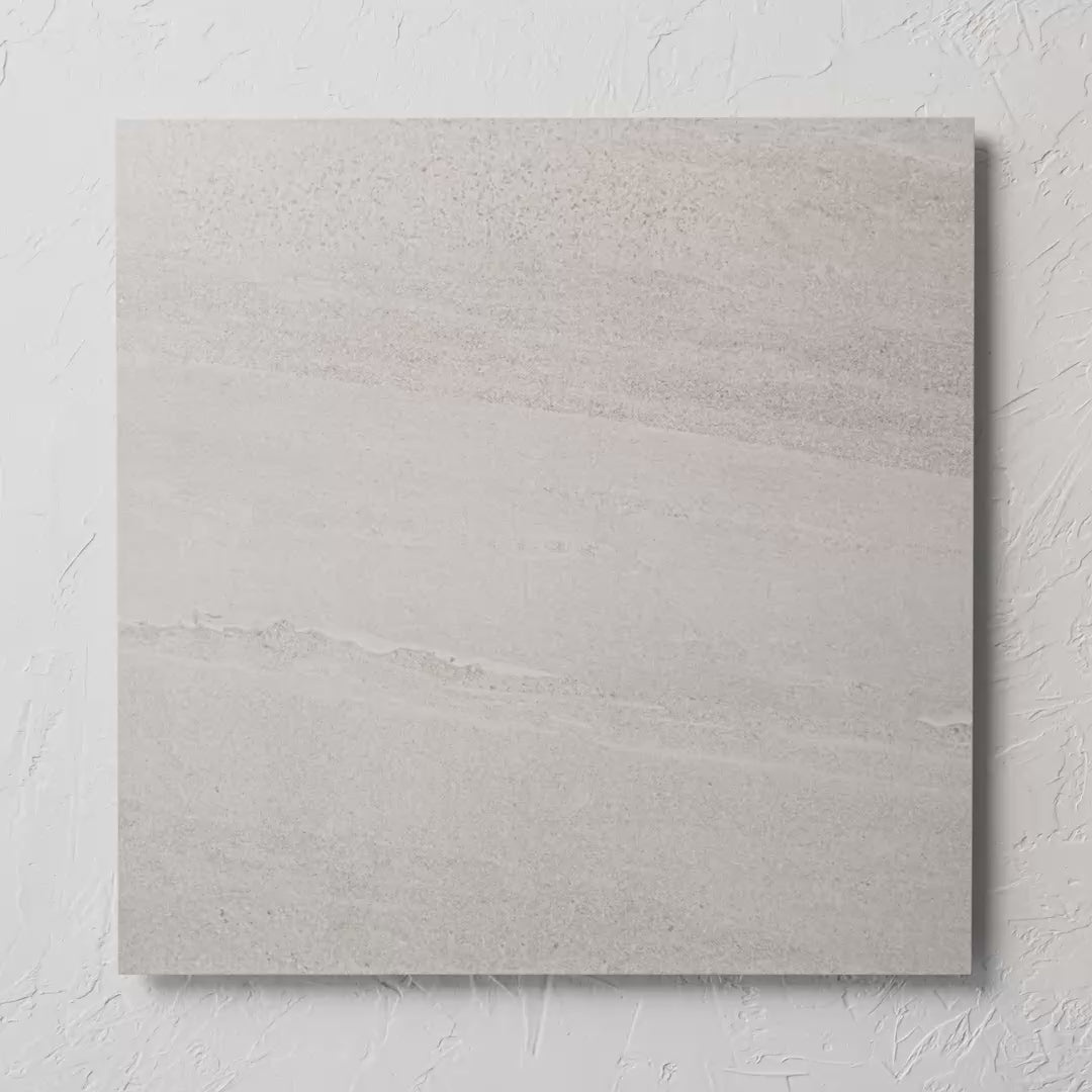 Riverstone White Matt 600X600Mm tile shown in hand