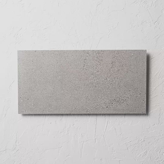 Oslo Cenere Rectified 300X600Mm tile shown in hand