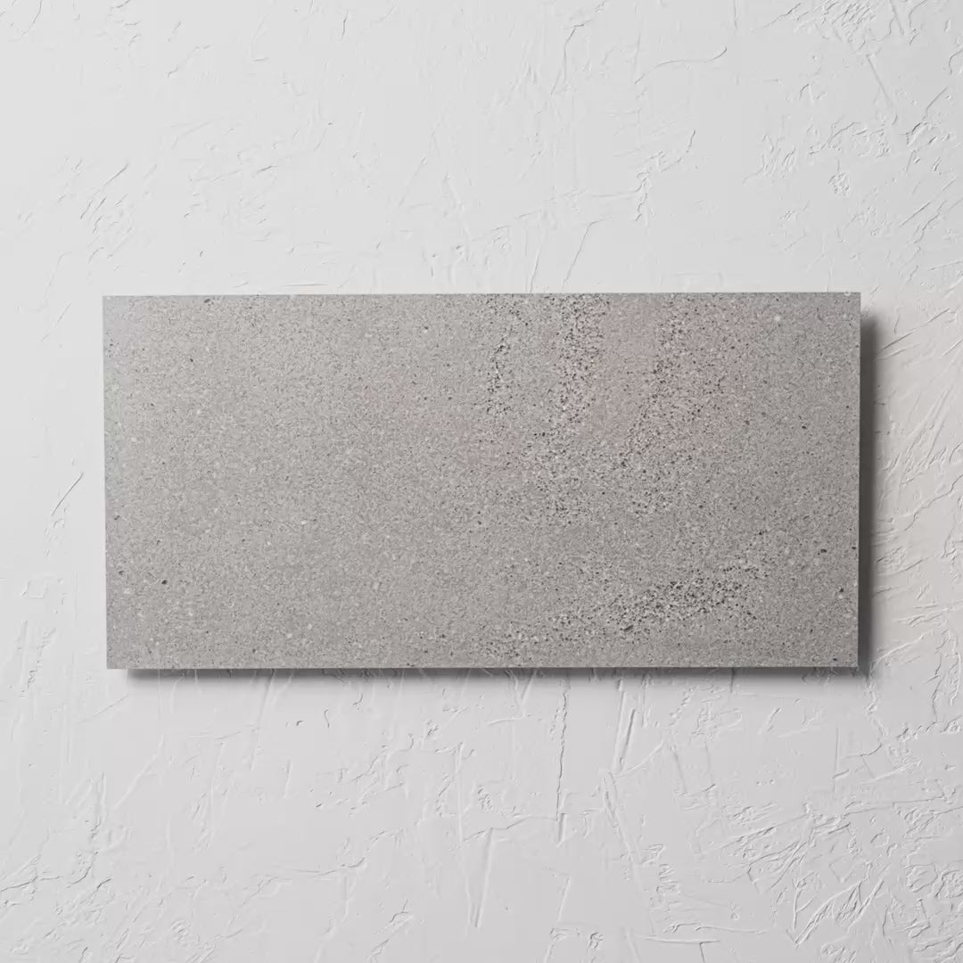 Oslo Cenere Rectified 300X600Mm tile shown in hand