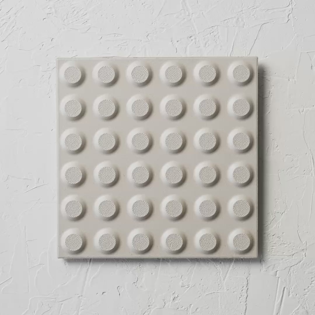 Hazard White Non Slip Tactile 300X300Mm tile shown in hand