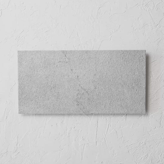 Courtyard Sterling Matt 300X600Mm tile shown in hand