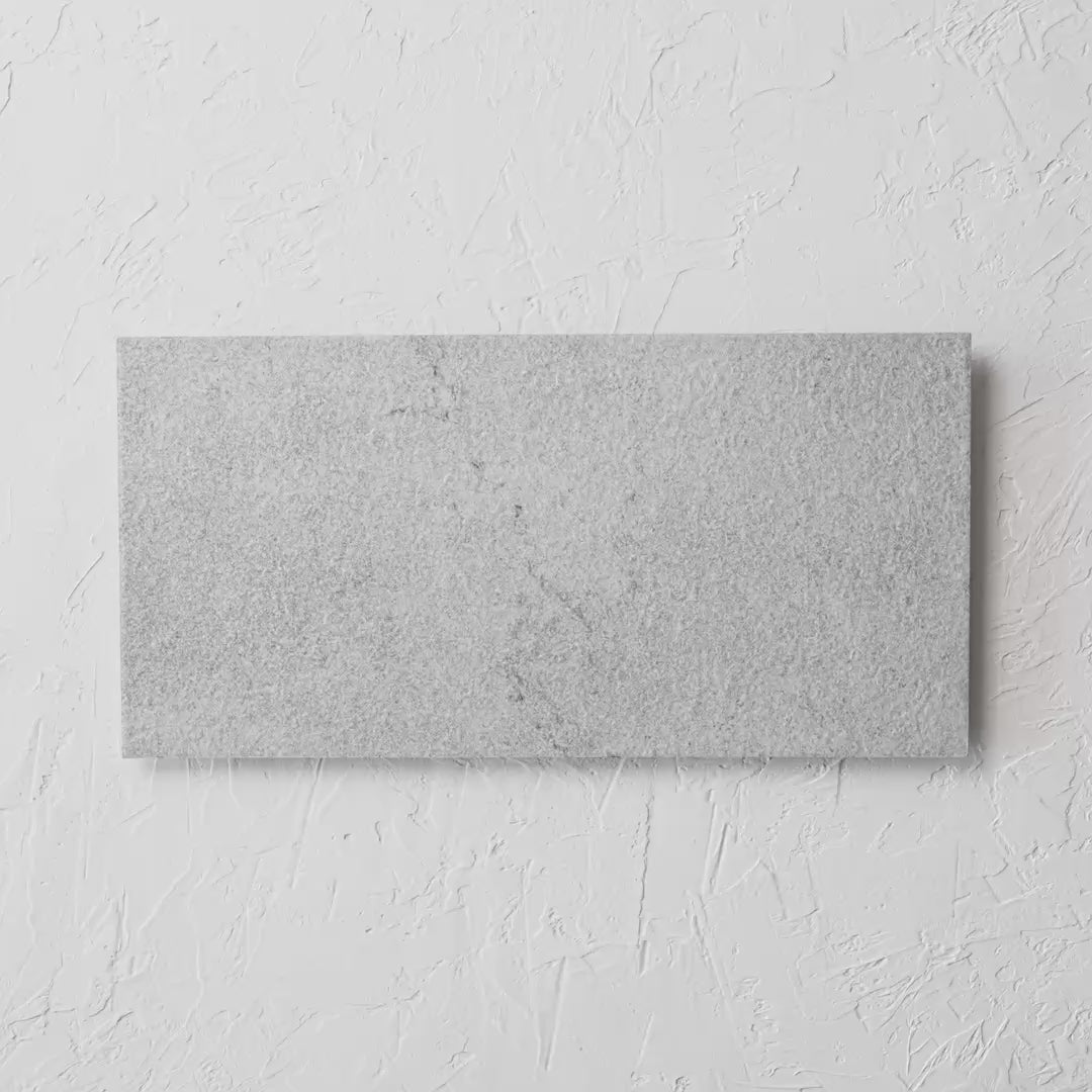 Courtyard Sterling Matt 300X600Mm tile shown in hand