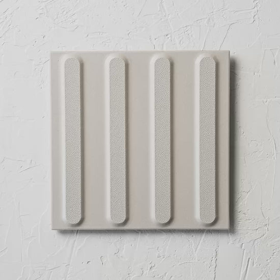 Directional White Non Slip Tactile 300X300Mm tile shown in hand