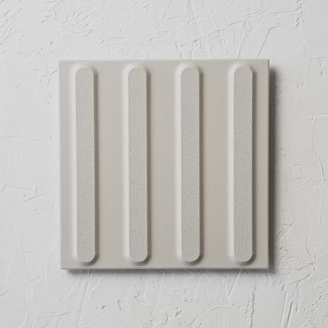 Directional White Non Slip Tactile 300X300Mm tile shown in hand