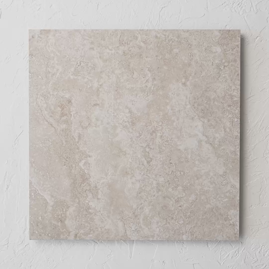 New Travertino Beige Polished Rectified 600X600Mm tile shown in hand