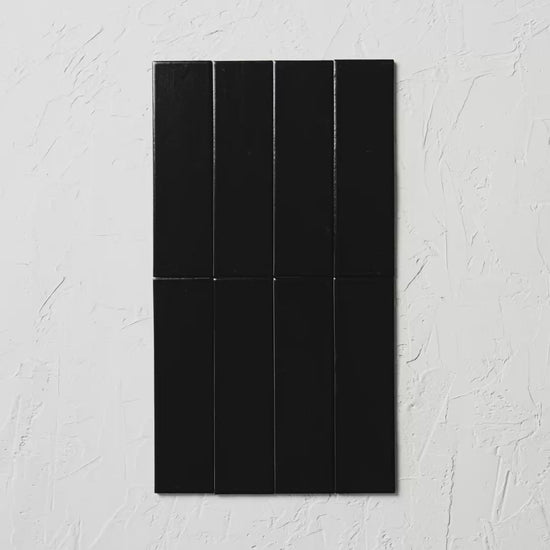 Brava Black Satin 60X217Mm tile shown in hand