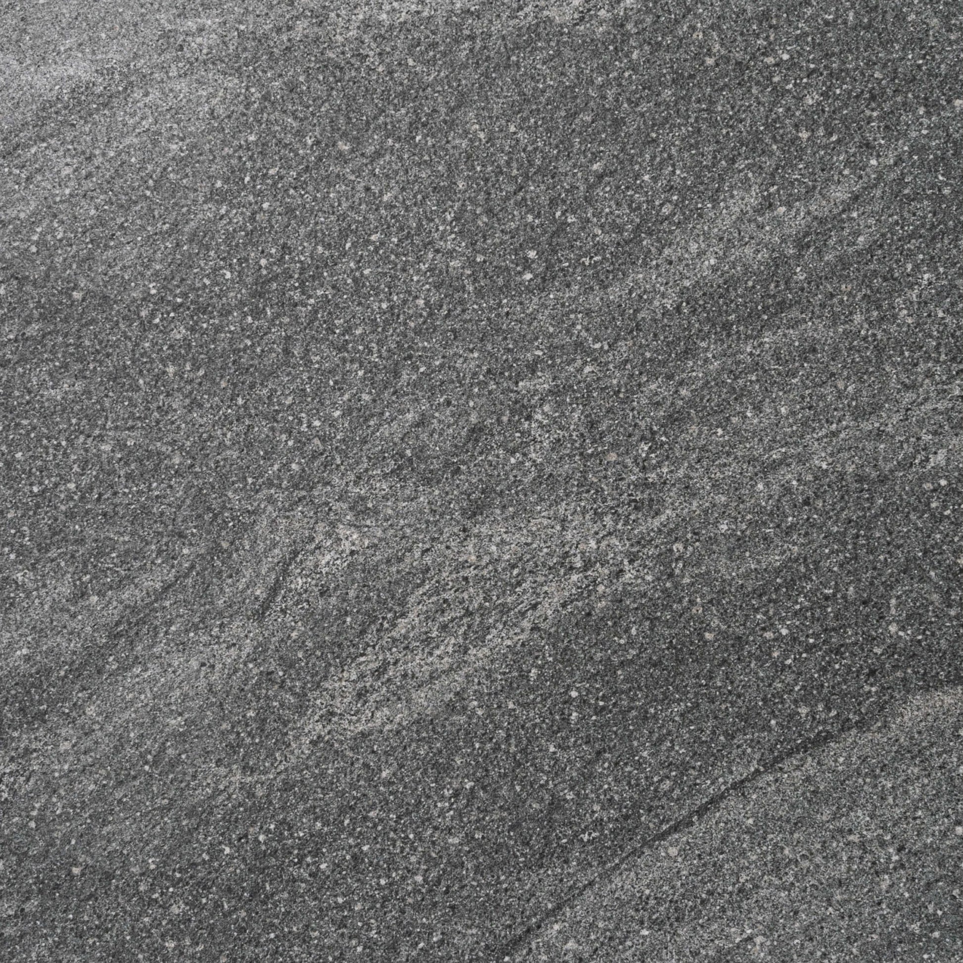 Close-up texture of the River Stone Dark Grey External Rectified Paver 600x600x20mm showing a fine-grained dark grey stone surface with natural mineral speckles and subtle veining.