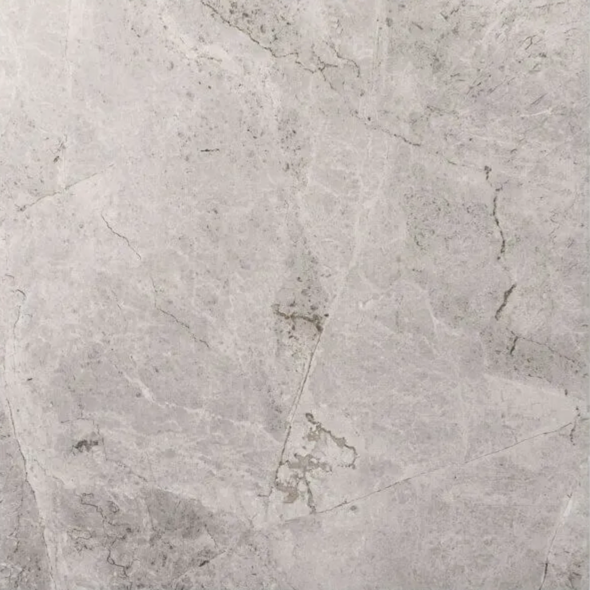 Close-up of Riviera Grigio 600x600mm porcelain tile showing a soft grey marble-effect surface with subtle veining and natural stone variation.