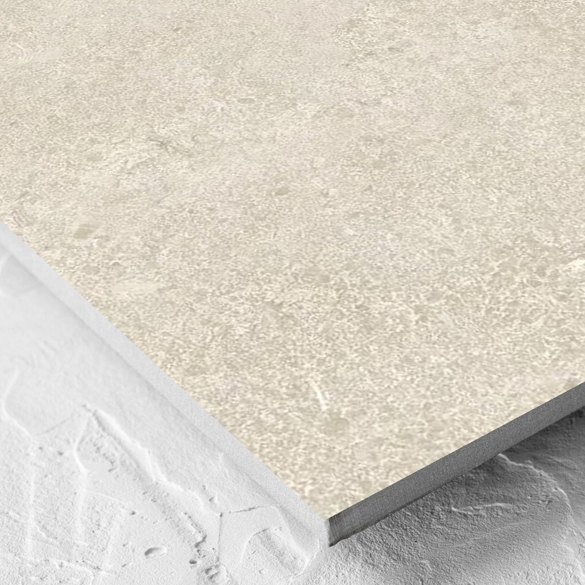 Corner close-up of the Roman Travertine Beige 600x600mm tile showing the beige matt surface and the edge profile