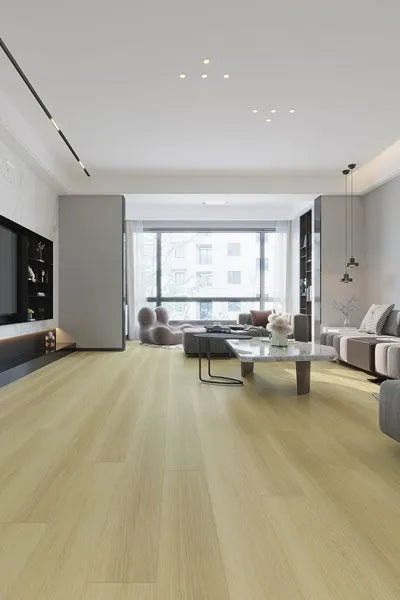 Sand Oak Urban Laminate 12mm Flooring 12mm installed in a spacious modern living room with grey sofa, marble coffee table, and floor-to-ceiling windows.