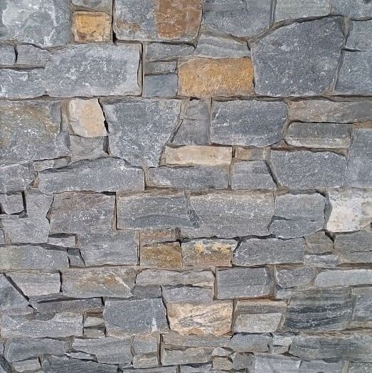 Close-up texture shot of Sapphire Mica Schist Z Panel Interlock 200x600mm showing irregular grey and golden-brown natural stone tiles in a stacked pattern.