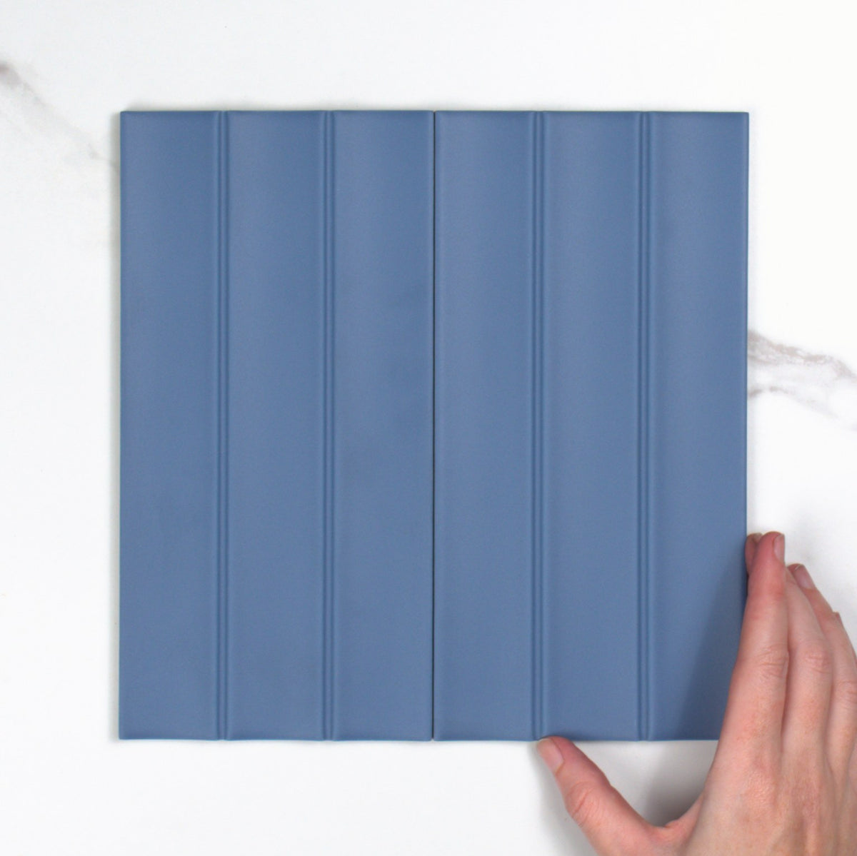 Scala Blu Matt 115x231mm top view, hand for scale