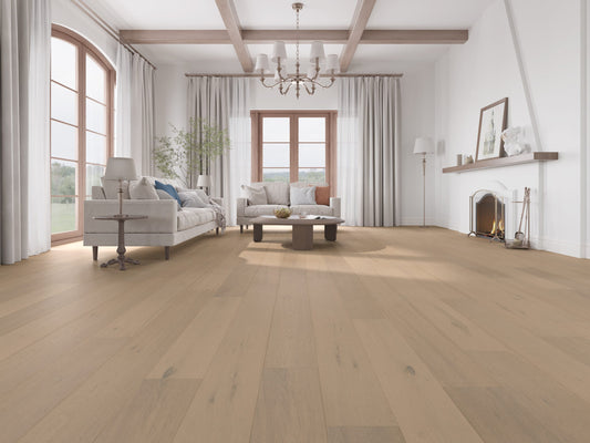Seashell Classique Oak Flooring 14/2mm installed in a bright spacious living room with light beige tones, coffered ceiling beams, and a lit fireplace.