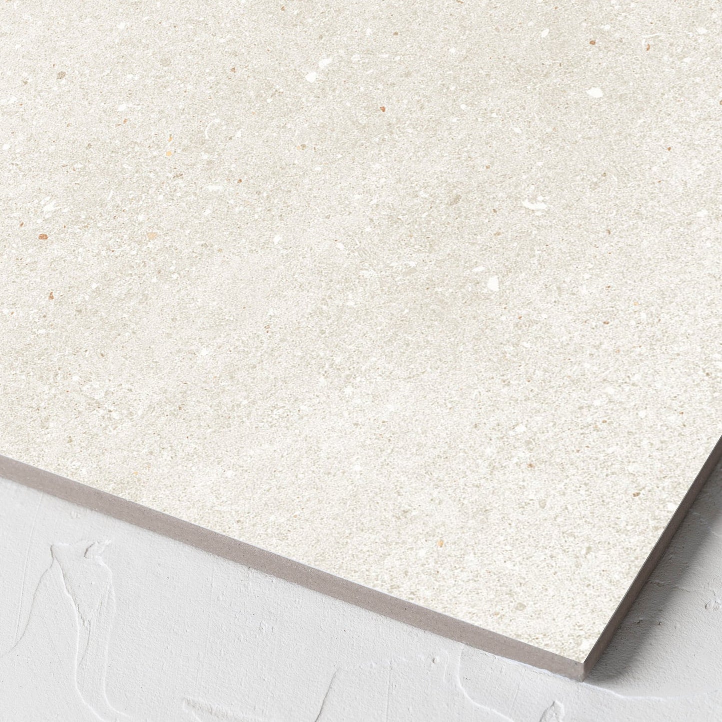 Corner close-up of the Serenity Beach Sand 300x300mm tile showing the matt surface and the edge profile