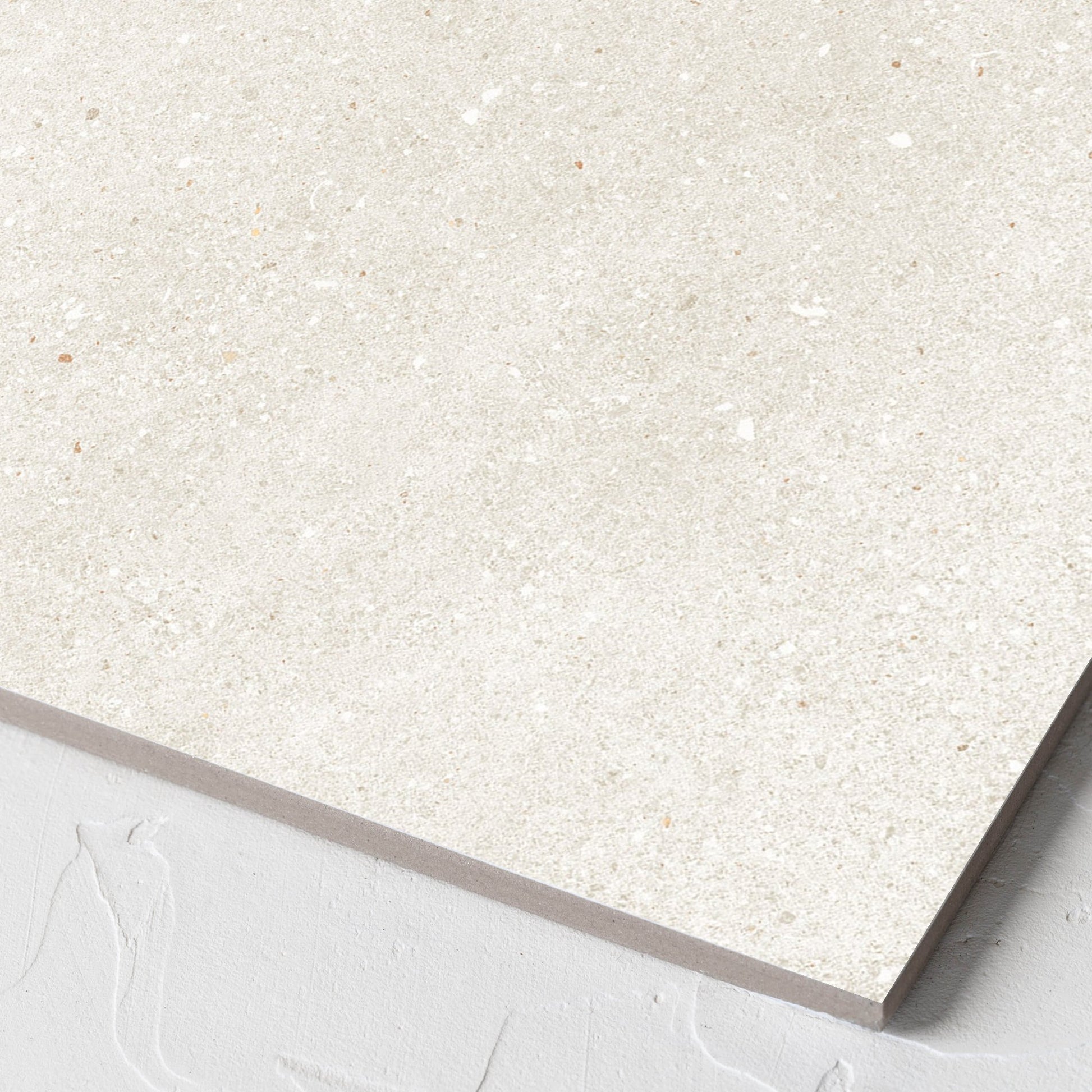 Corner close-up of the Serenity Beach Sand 300x300mm tile showing the matt surface and the edge profile