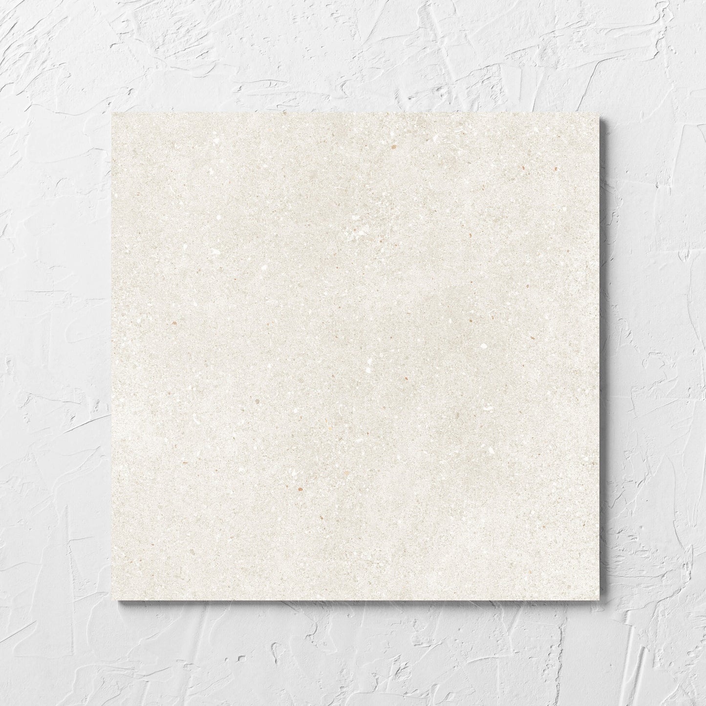 Serenity Beach Sand 300x300mm tile laid flat on a white rendered wall, showing the matt surface