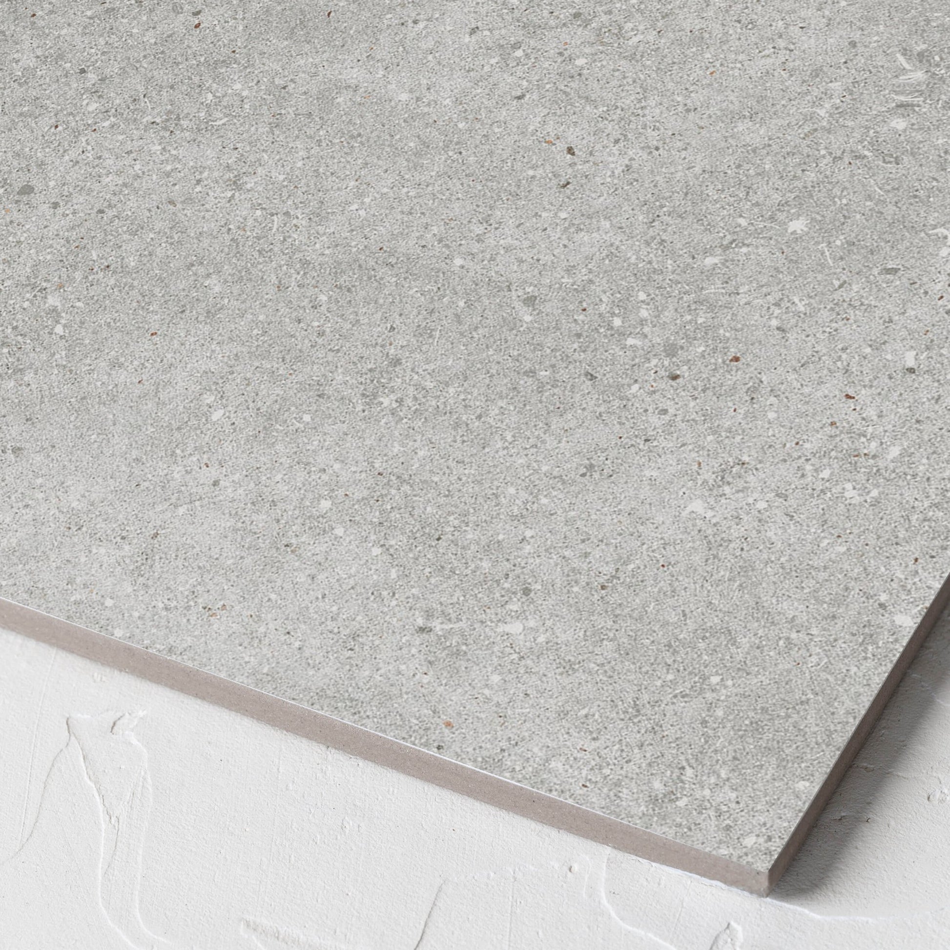 Corner close-up of the Serenity Concrete Grey 300x300mm tile showing the matt surface and the edge profile