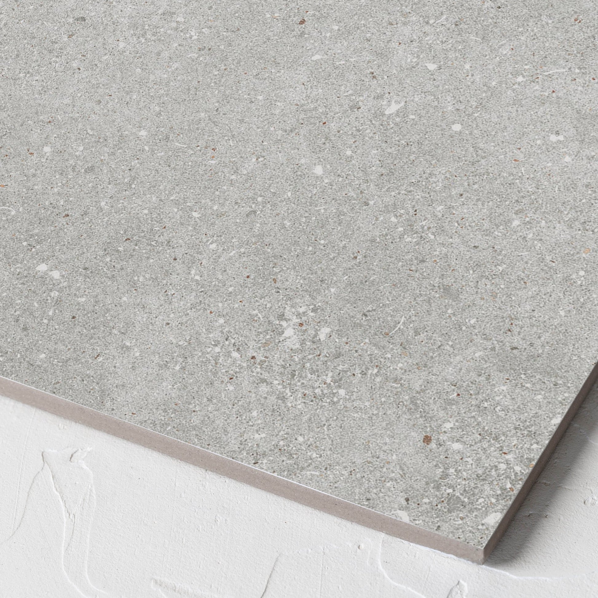 Corner close-up of the Serenity Urban Stone 300x300mm tile showing the matt surface and the edge profile