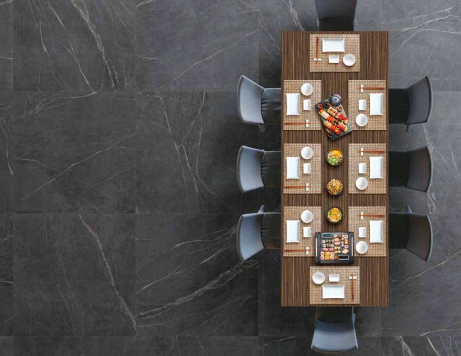 Soap Stone Black 600x600mm dark marble-effect floor tiles beneath a top-down view of a styled Japanese dining table with sushi and place settings.