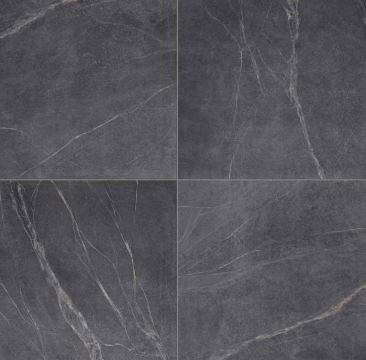 Close-up texture shot of Soap Stone Black Natural 600x1200mm tiles showing dark charcoal surface with natural white veining across four tile layout.