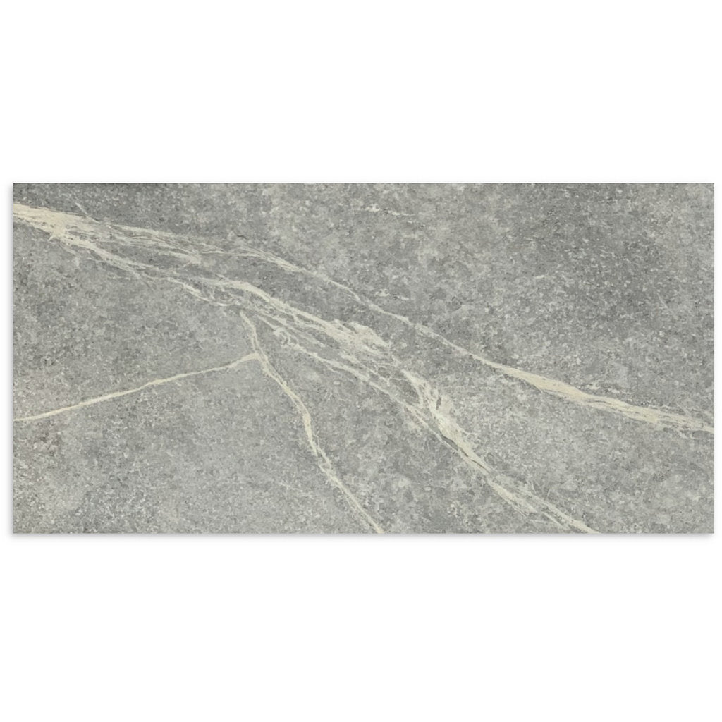 Close-up of Soap Stone Grey Honed 600x1200mm tile showing a mid-grey stone surface with natural white veining and a matte honed finish.