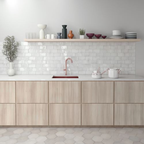 Spanish Handmade Gloss White 75x150mm tiles used as a kitchen splashback behind a rose gold tap, paired with light timber cabinetry and open shelf styling.