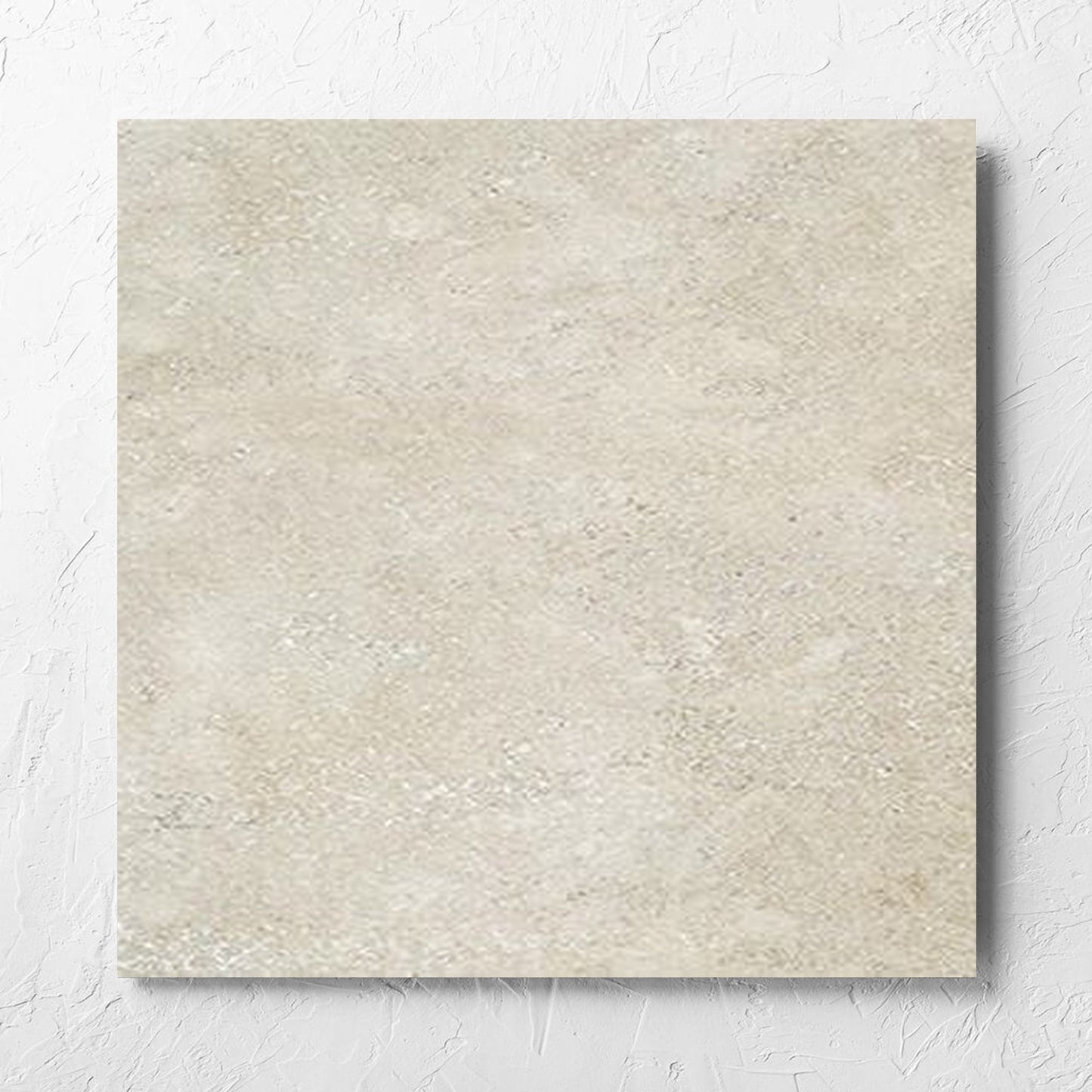 Stella Beige Lappato 600x600mm tile laid flat on a white rendered wall, showing the beige lappato surface